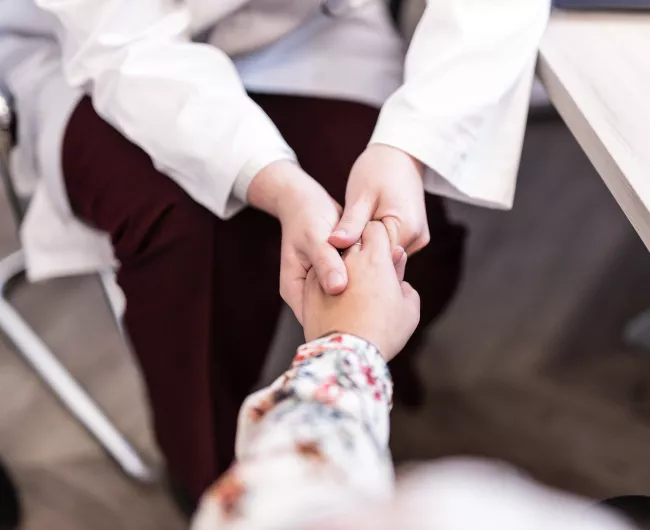 provider holds a patient's hand