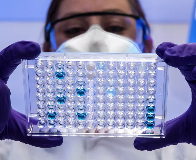 female scientist holding a sample tray 