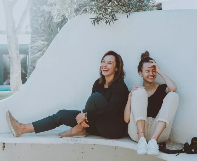 two young women laughing 