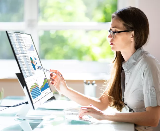 woman analyzing data on a computer monitor