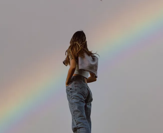 woman looking at rainbow