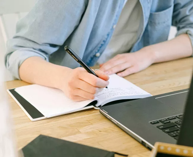 woman taking notes