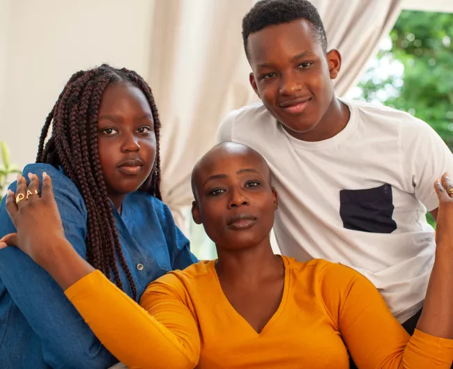 Woman with two kids looking at camera