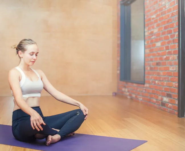 Woman in yoga studio doing a basic pose