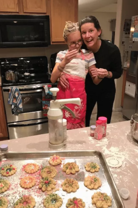 Marleigh baking cookies with her mom, Angela, after her father's death from colorectal cancer in 2016.
