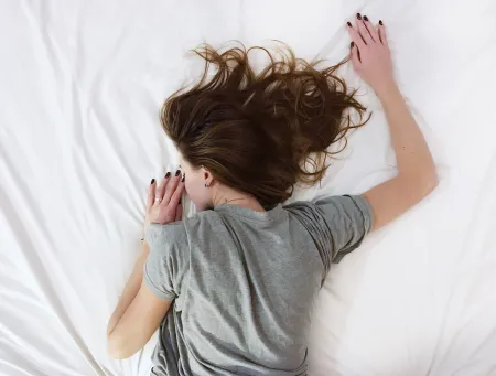 woman in pain on bed